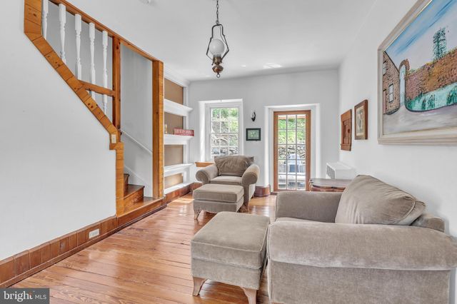 a living room with furniture ceiling fan and a window