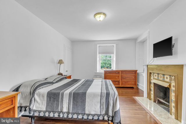 a bedroom with a bed and a fireplace