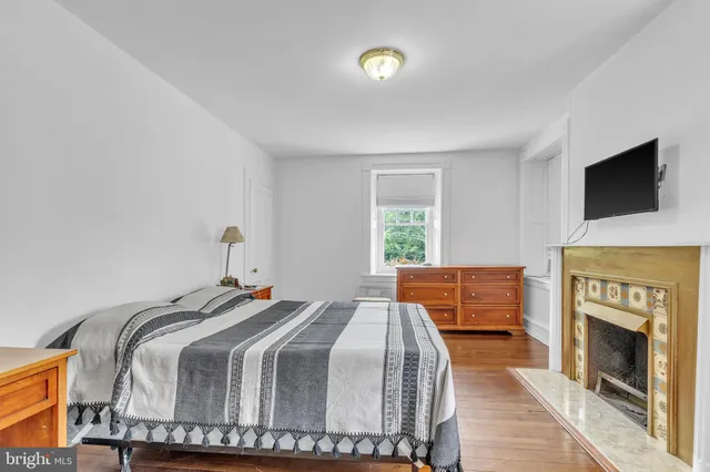 a bedroom with a bed and a fireplace