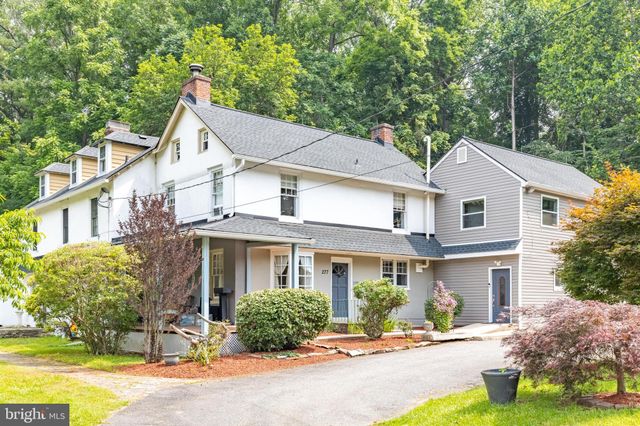 a front view of a house with a yard and outdoor seating