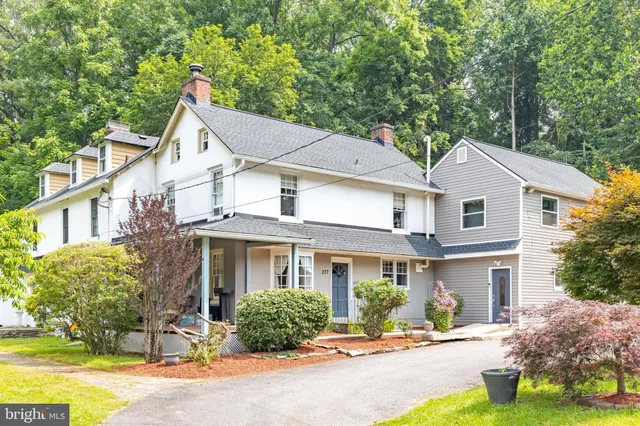 a front view of a house with a yard and outdoor seating