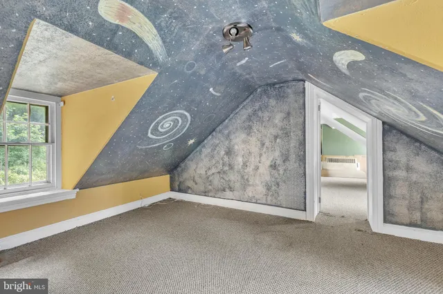 a view of an empty room with windows