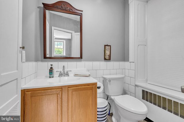a bathroom with a toilet sink and mirror