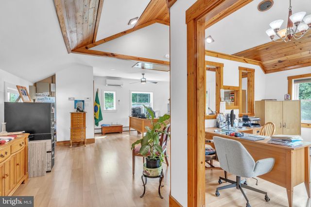 a view of a livingroom with furniture and a flat screen tv