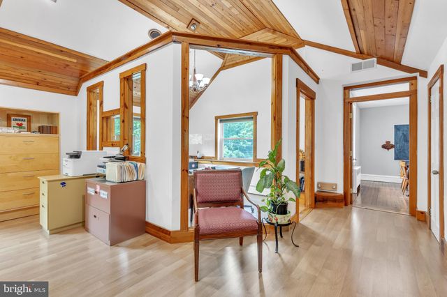 a workspace with furniture window and wooden floor