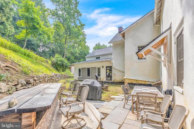 a view of a patio with table and chairs with wooden floor and fence