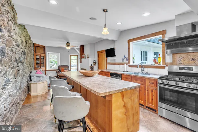 a kitchen with sink stove and refrigerator