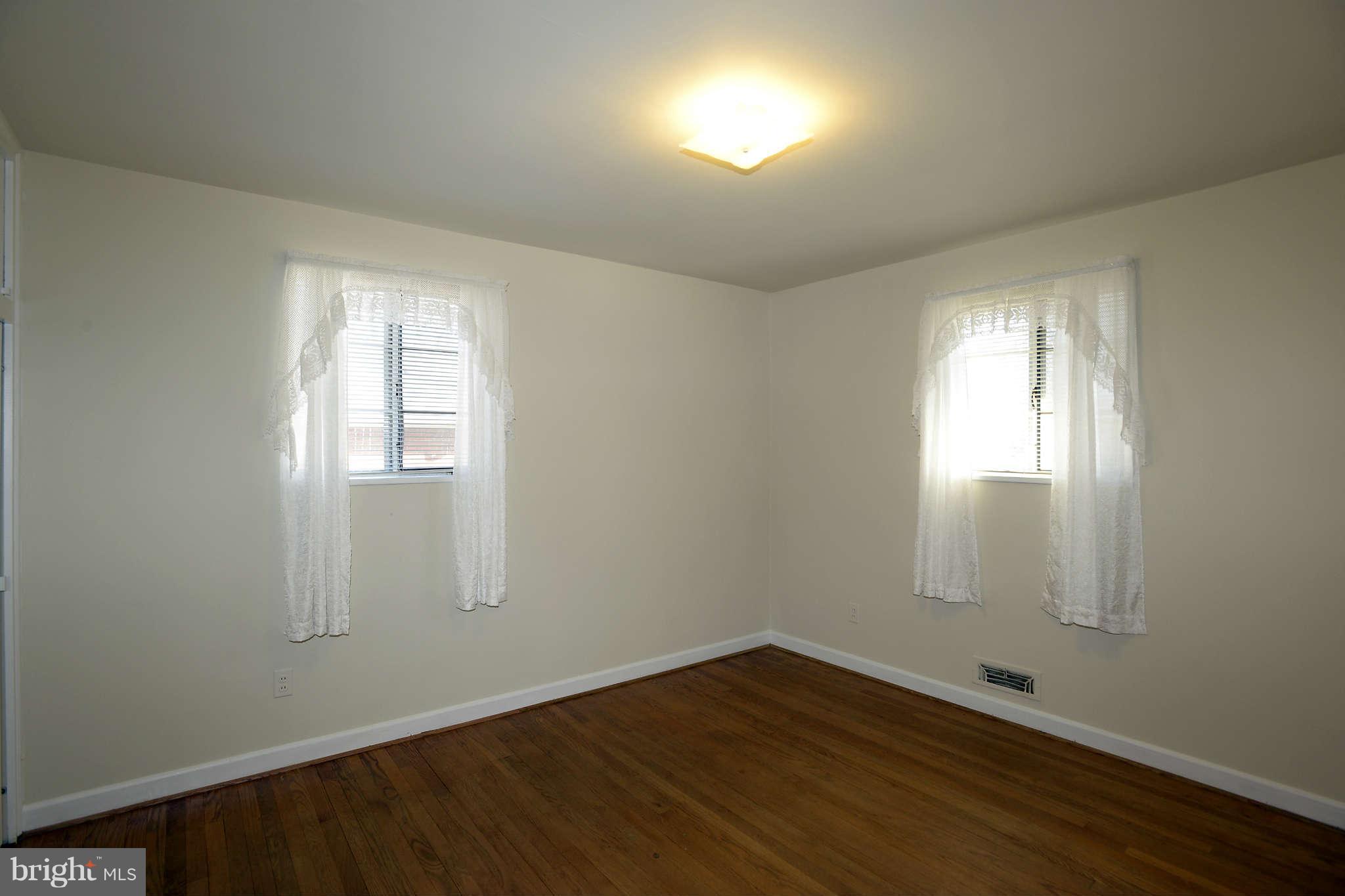 3913 Isbell Street Silver Spring, MD 20906 - Photo 11 of 23 an empty room with wooden floor and windows