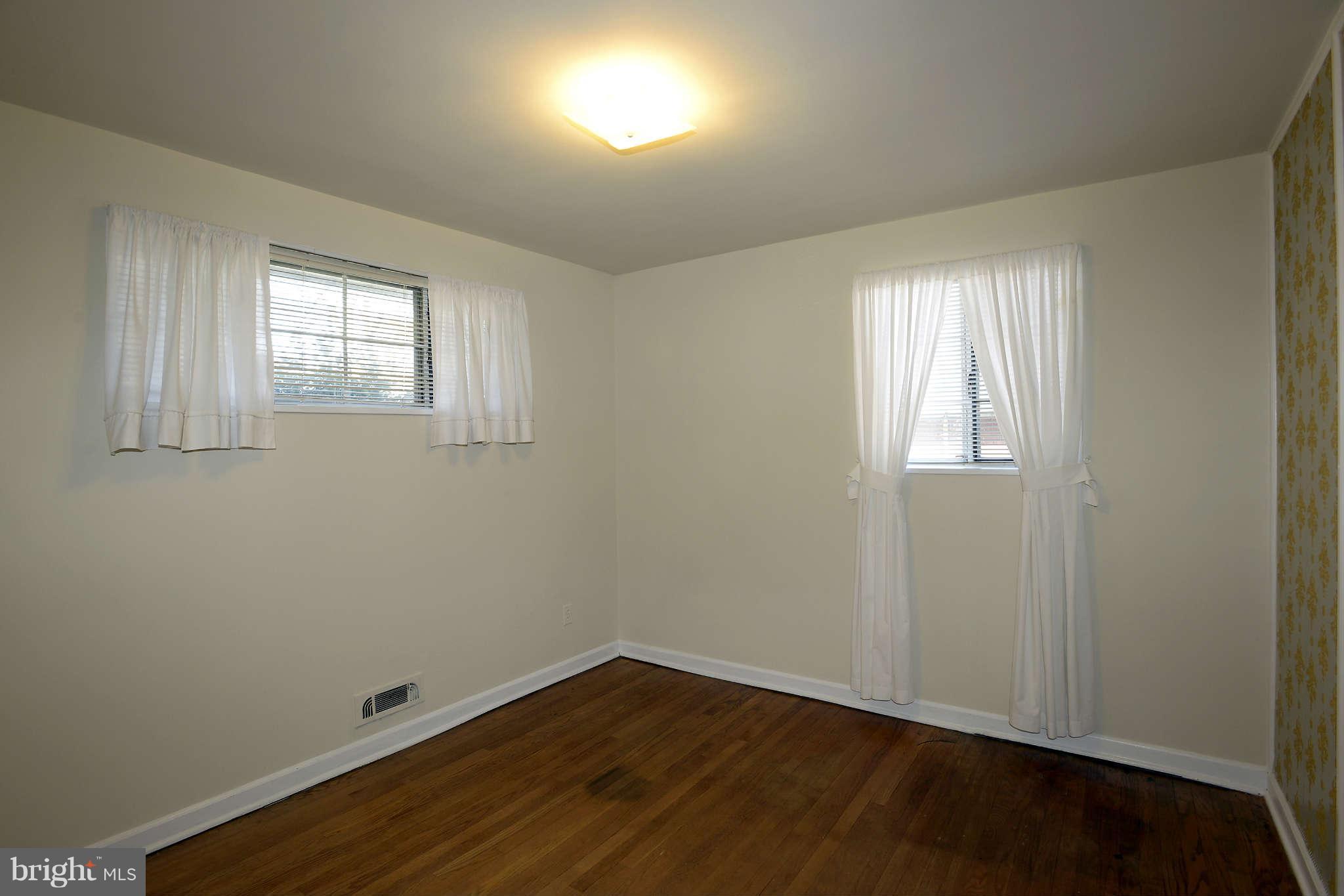 3913 Isbell Street Silver Spring, MD 20906 - Photo 12 of 23 an empty room with wooden floor and windows