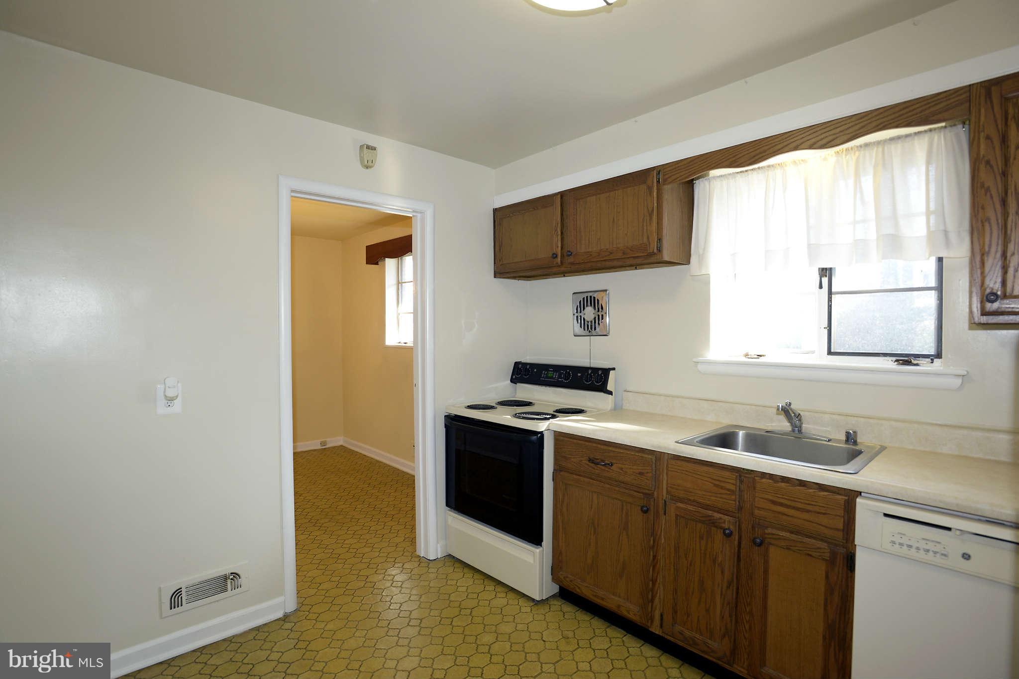 3913 Isbell Street Silver Spring, MD 20906 - Photo 6 of 23 a kitchen with stainless steel appliances granite countertop a stove a sink and a microwave
