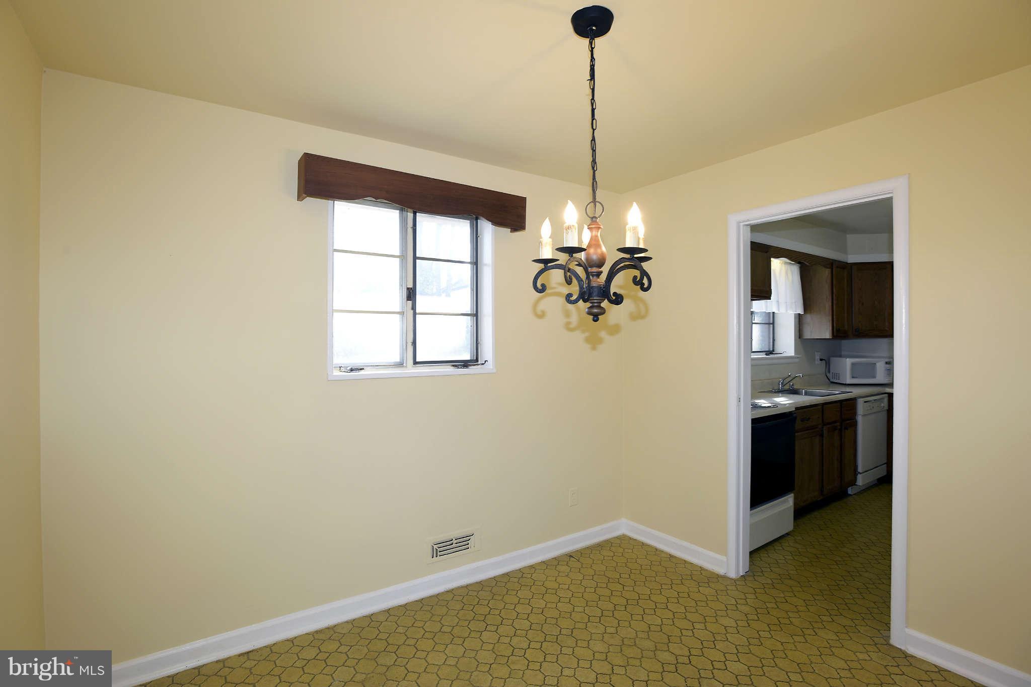3913 Isbell Street Silver Spring, MD 20906 - Photo 10 of 23 a view of a kitchen with a stove cabinets and a wooden floor