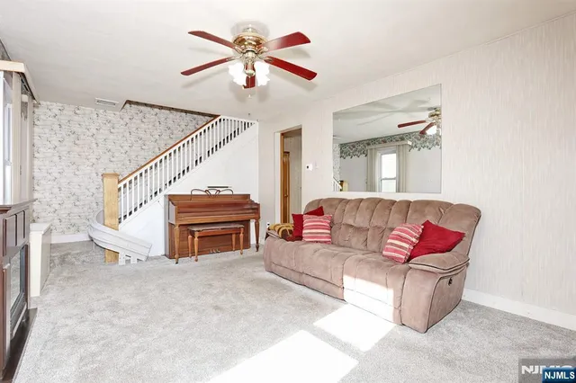 a living room with furniture and a chandelier