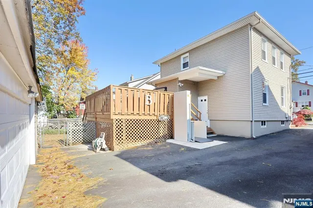 a view of a house with wooden fence