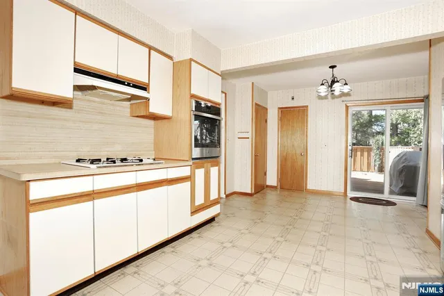 a view of a kitchen with a stove cabinets and a kitchen view