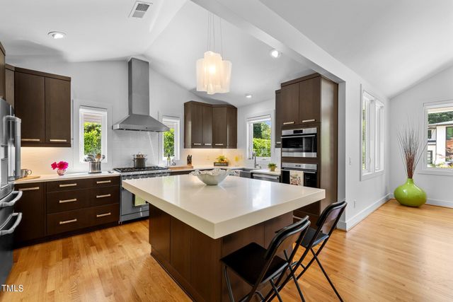 a kitchen with a stove a refrigerator and a sink