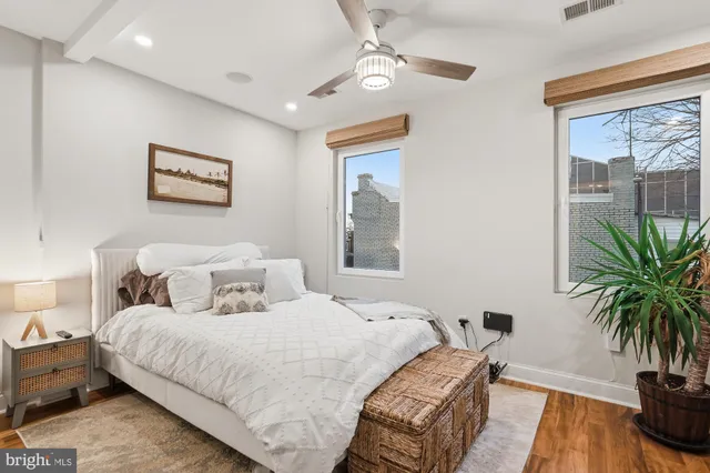 a bedroom with bed and a potted plant