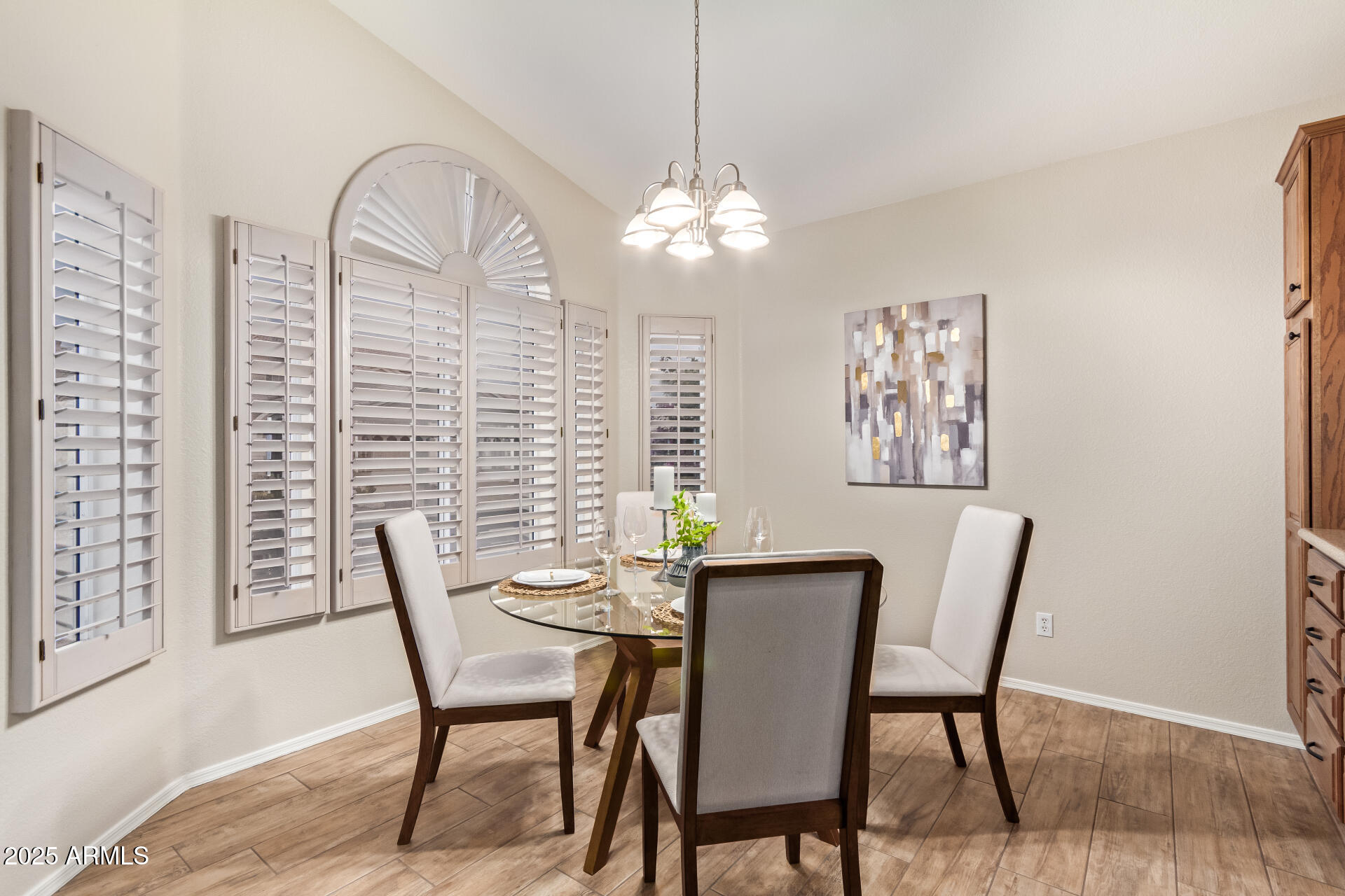 15596 West Flower Court Goodyear, AZ 85395 - Photo 15 of 35 a view of a dining room with furniture window and wooden floor