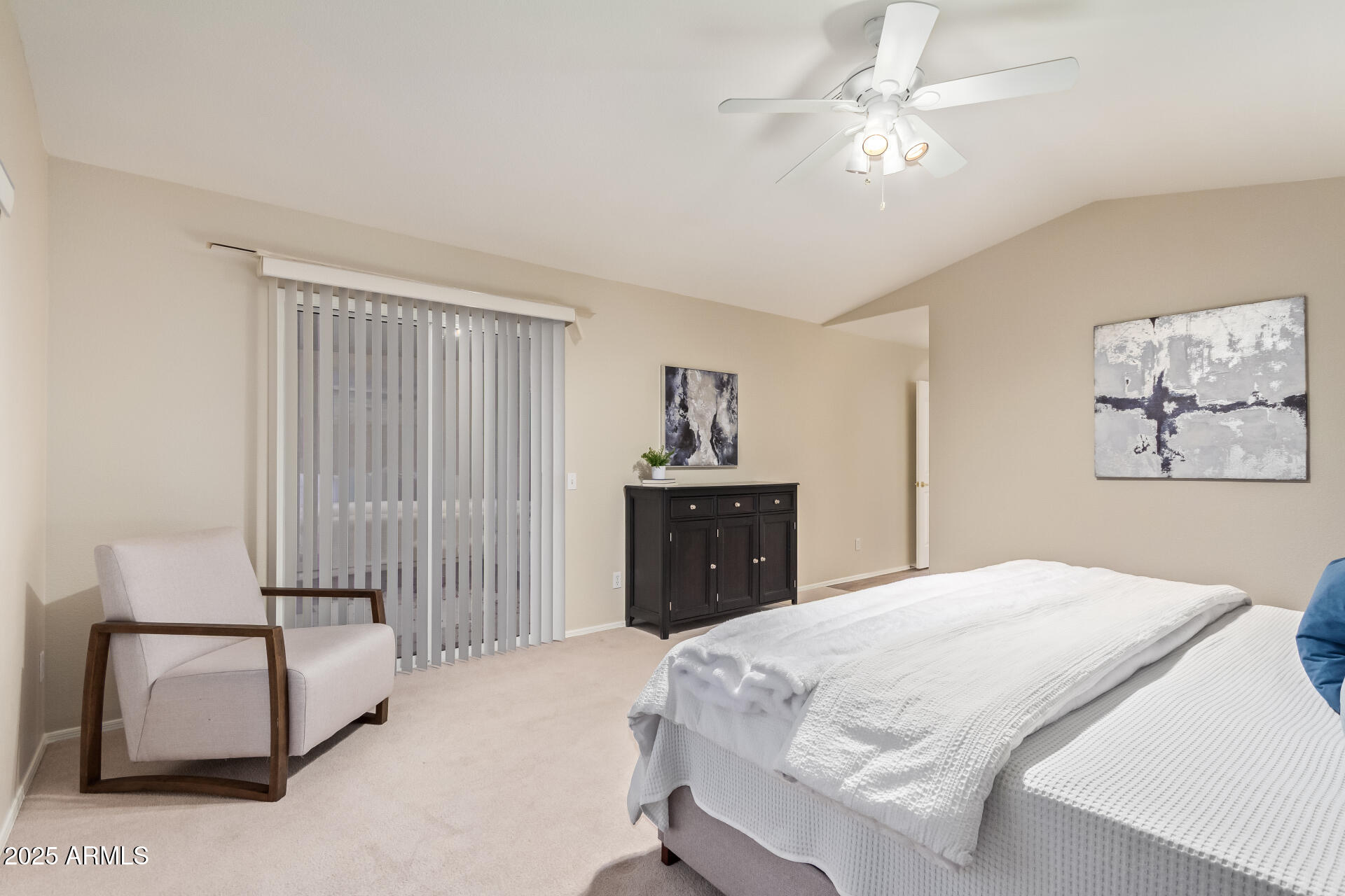 15596 West Flower Court Goodyear, AZ 85395 - Photo 21 of 35 a bedroom with a bed and a chandelier
