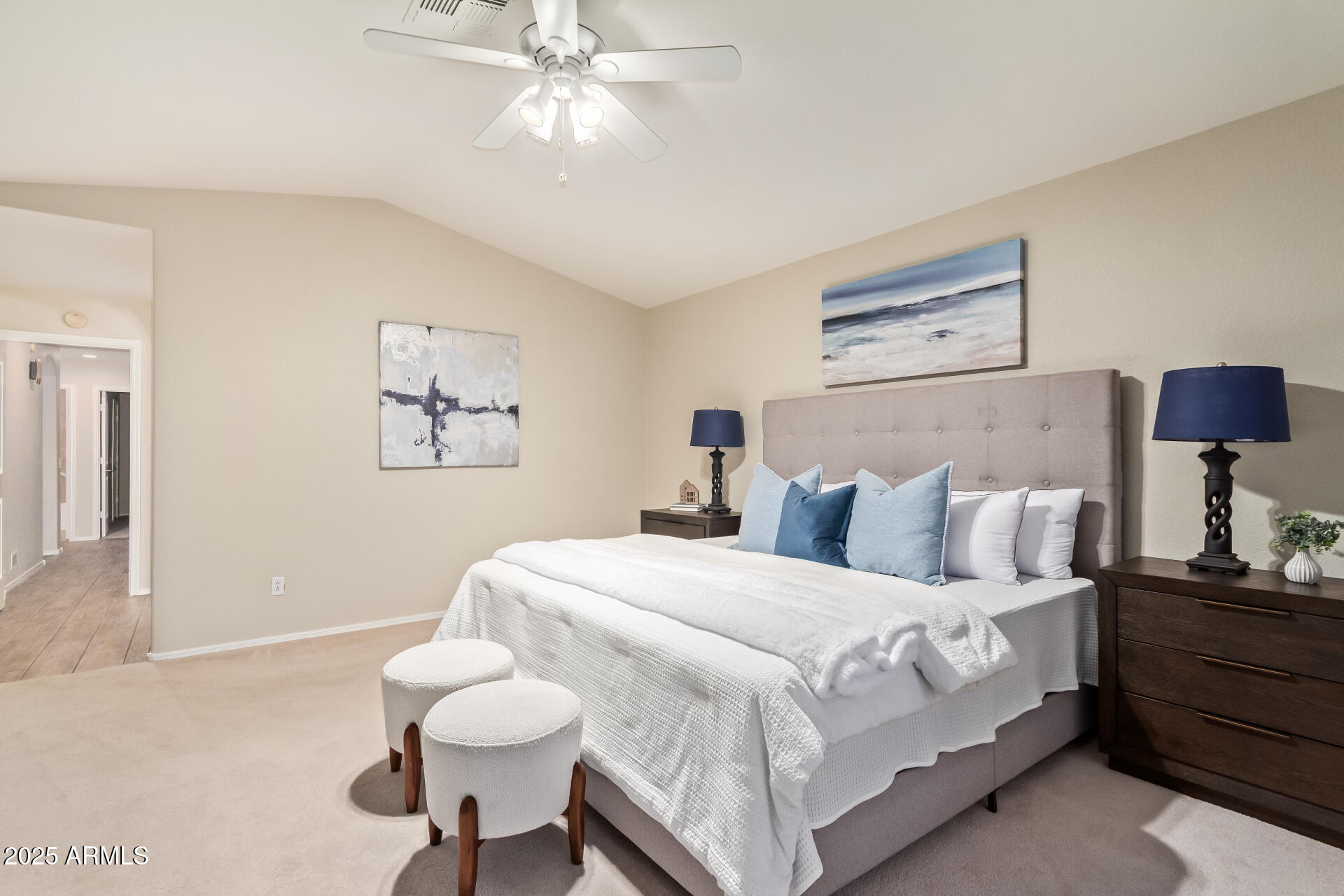15596 West Flower Court Goodyear, AZ 85395 - Photo 22 of 35 a bedroom with a bed and a chandelier