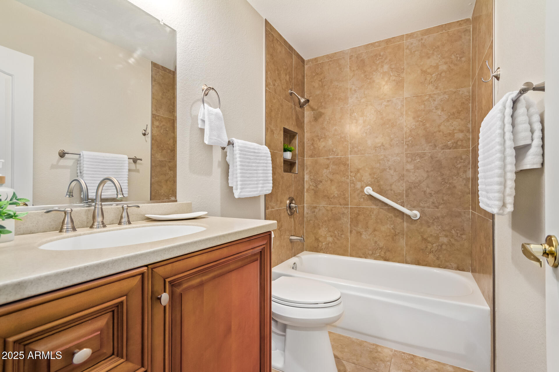 15596 West Flower Court Goodyear, AZ 85395 - Photo 28 of 35 a bathroom with a sink a toilet and shower