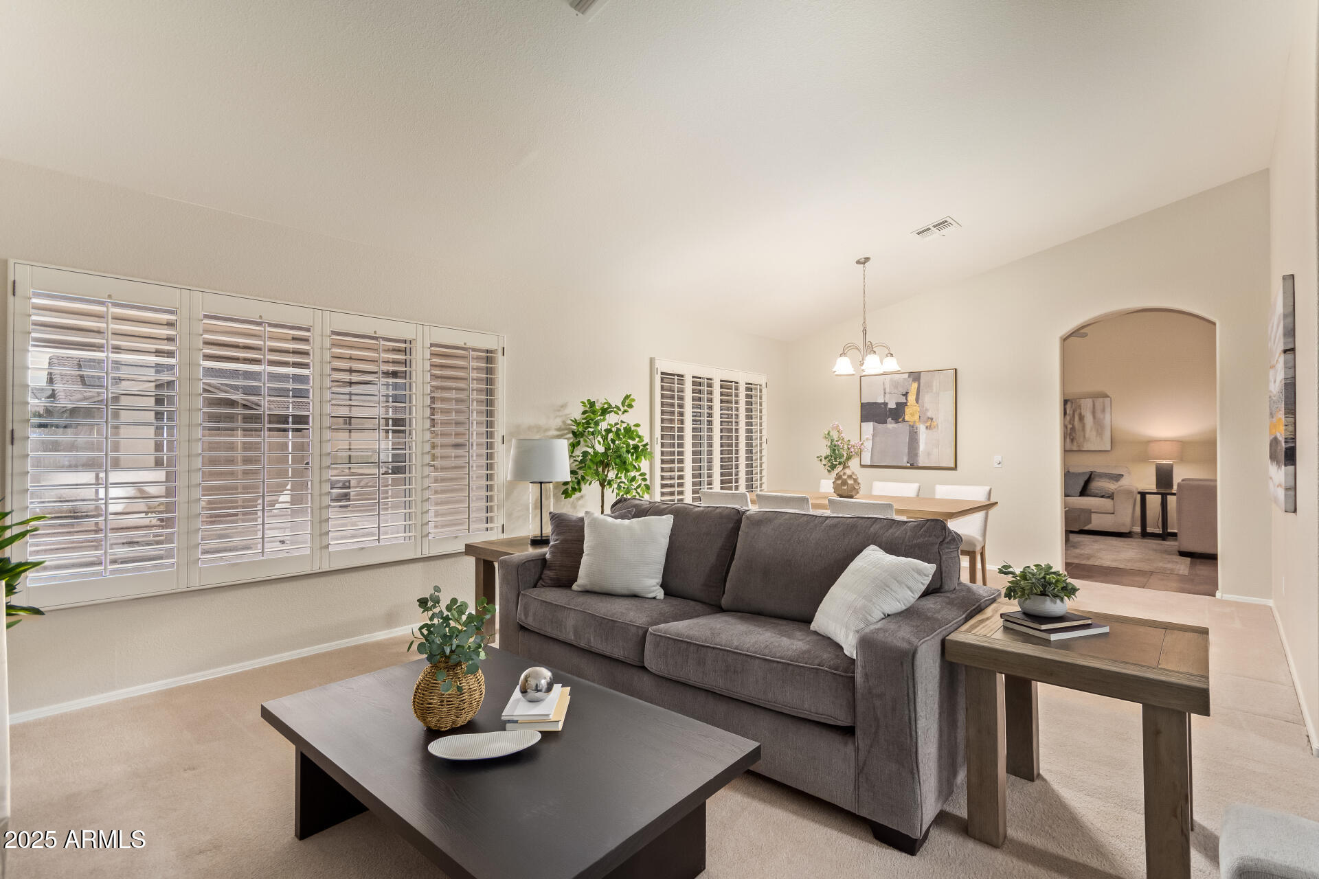 15596 West Flower Court Goodyear, AZ 85395 - Photo 8 of 35 a living room with furniture and a large window