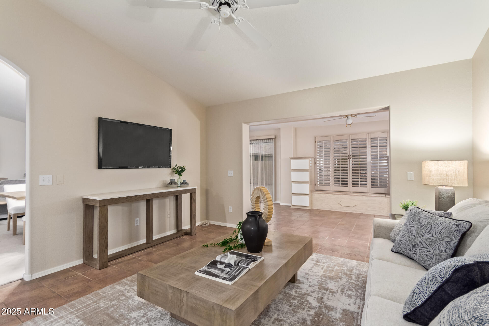 15596 West Flower Court Goodyear, AZ 85395 - Photo 10 of 35 a living room with furniture and a flat screen tv