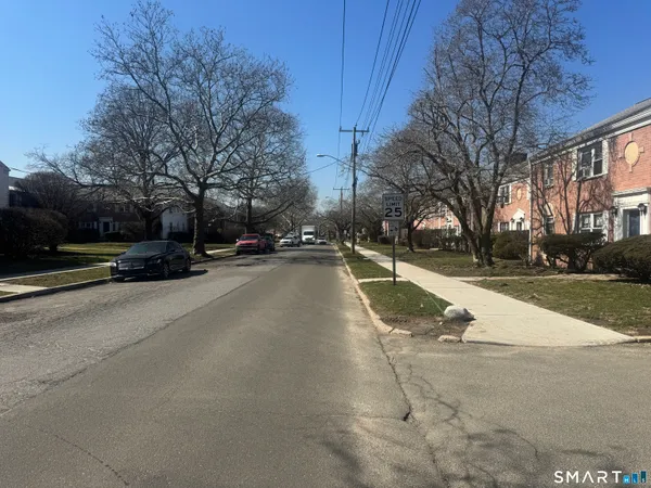 a view of a street with houses on both side of it