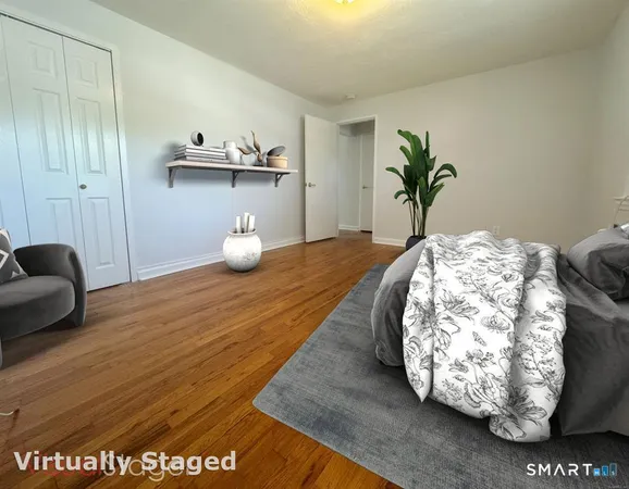 a bedroom with a bed and painting on the wall