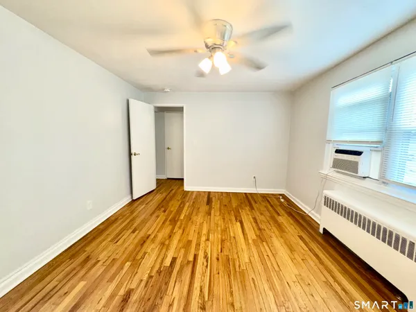 a view of an empty room and wooden floor