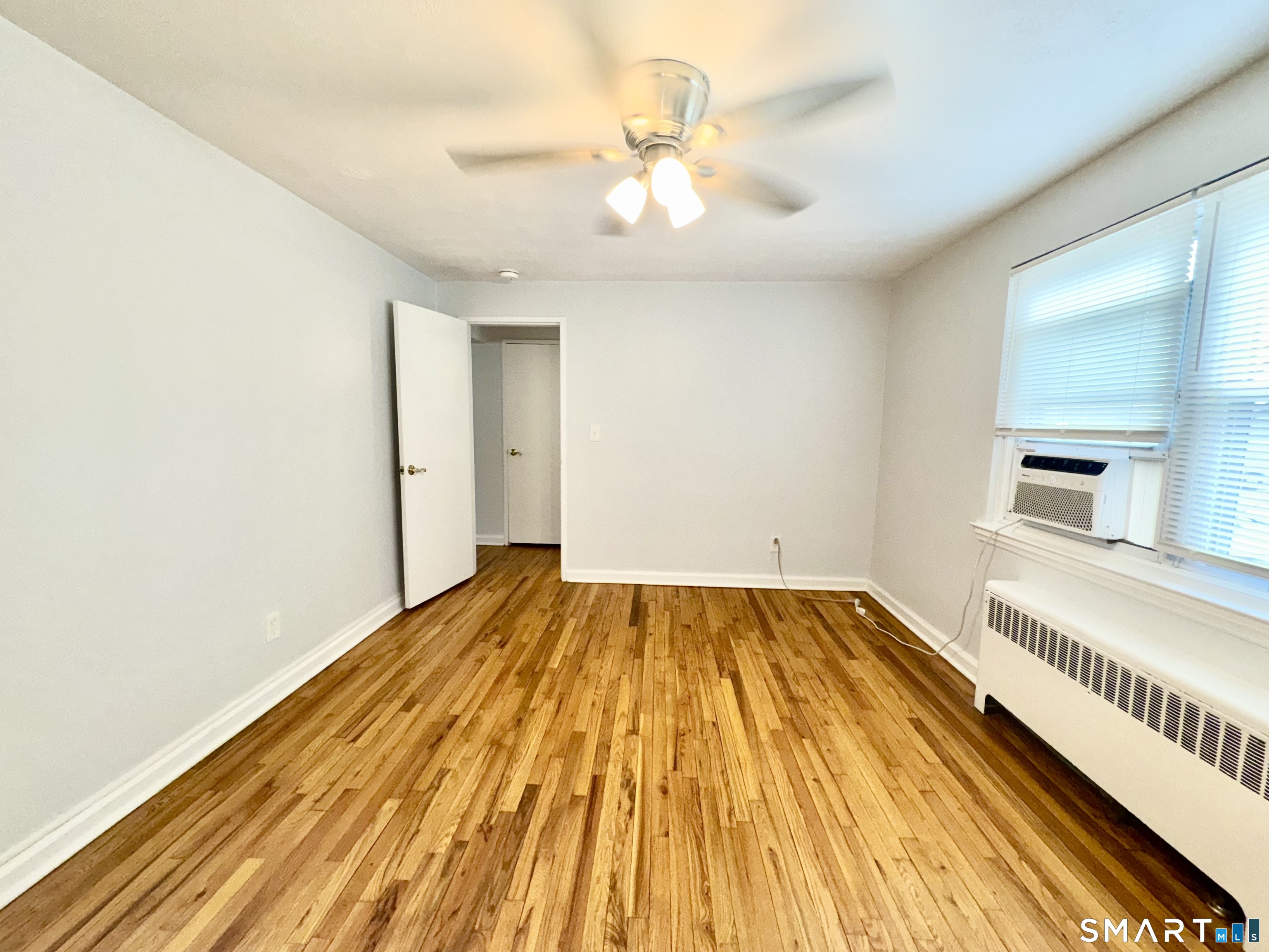 246 Seaton Road, Unit 2 Stamford, CT 06902 - Photo 9 of 18 a view of an empty room and wooden floor