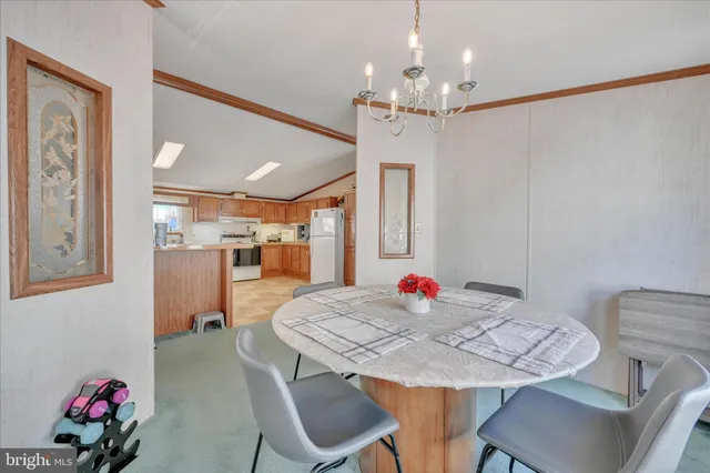 a bedroom with a large bed and a chandelier fan