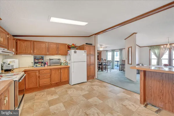 a kitchen with a refrigerator sink and cabinets
