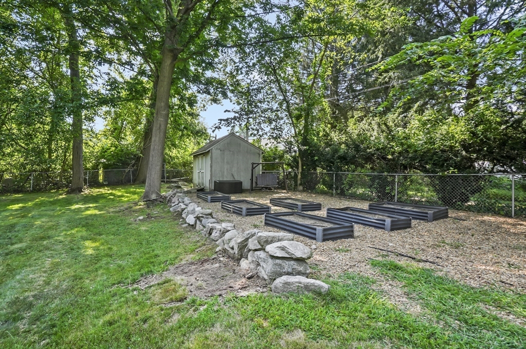 9 Oregon Road Southborough, MA 01772 - Photo 25 of 27 a view of a bench in the garden near a lake