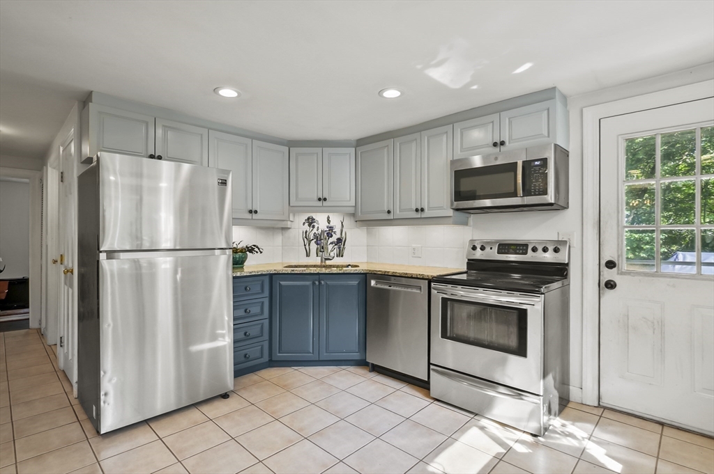 9 Oregon Road Southborough, MA 01772 - Photo 9 of 27 a kitchen with cabinets stainless steel appliances and a counter top space