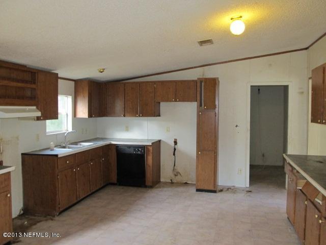 6359 Memory Lane Jacksonville, FL 32234 - Photo 4 of 11 a kitchen with a sink and a refrigerator