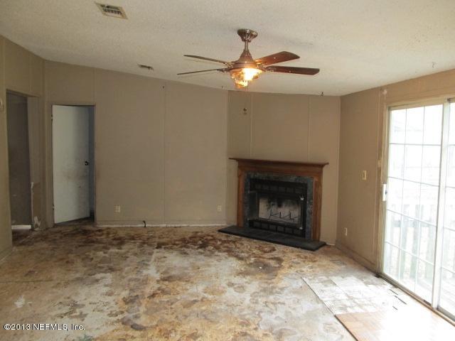 6359 Memory Lane Jacksonville, FL 32234 - Photo 5 of 11 a view of an empty room with window and fire place