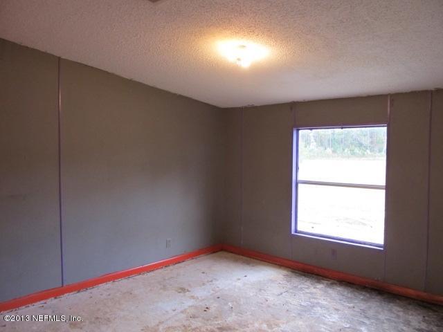 6359 Memory Lane Jacksonville, FL 32234 - Photo 8 of 11 an empty room with a window