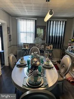 a table with chairs and a potted plant