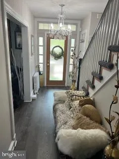 a living room with fireplace furniture and a chandelier