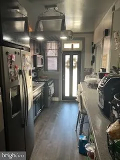 a kitchen with stainless steel appliances a refrigerator a sink a stove and cabinets