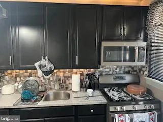 a kitchen with a stove and cabinets