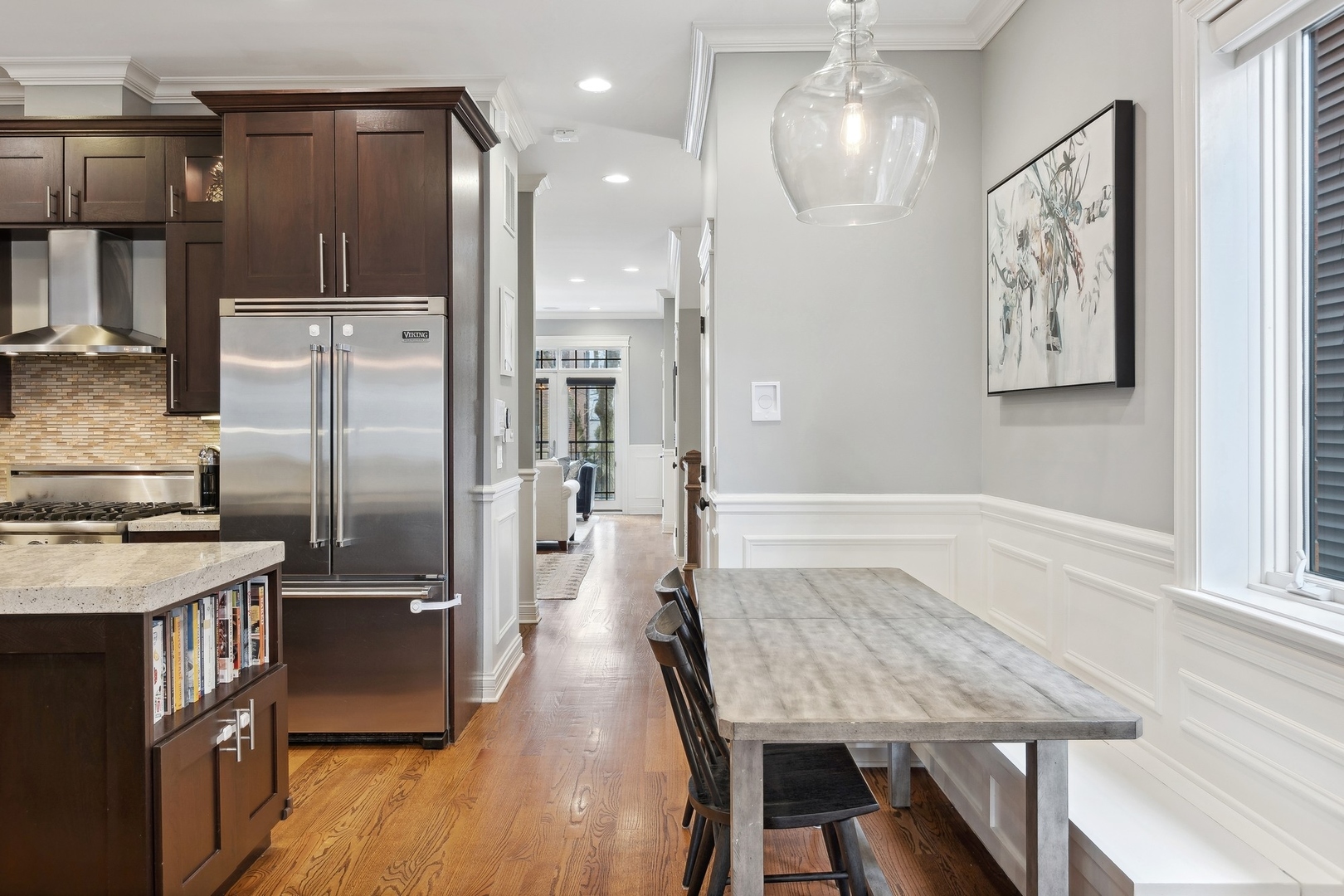 1520 West Diversey Parkway, Unit 1 Chicago, IL 60614 - Photo 11 of 31 a kitchen with a table chairs refrigerator and microwave