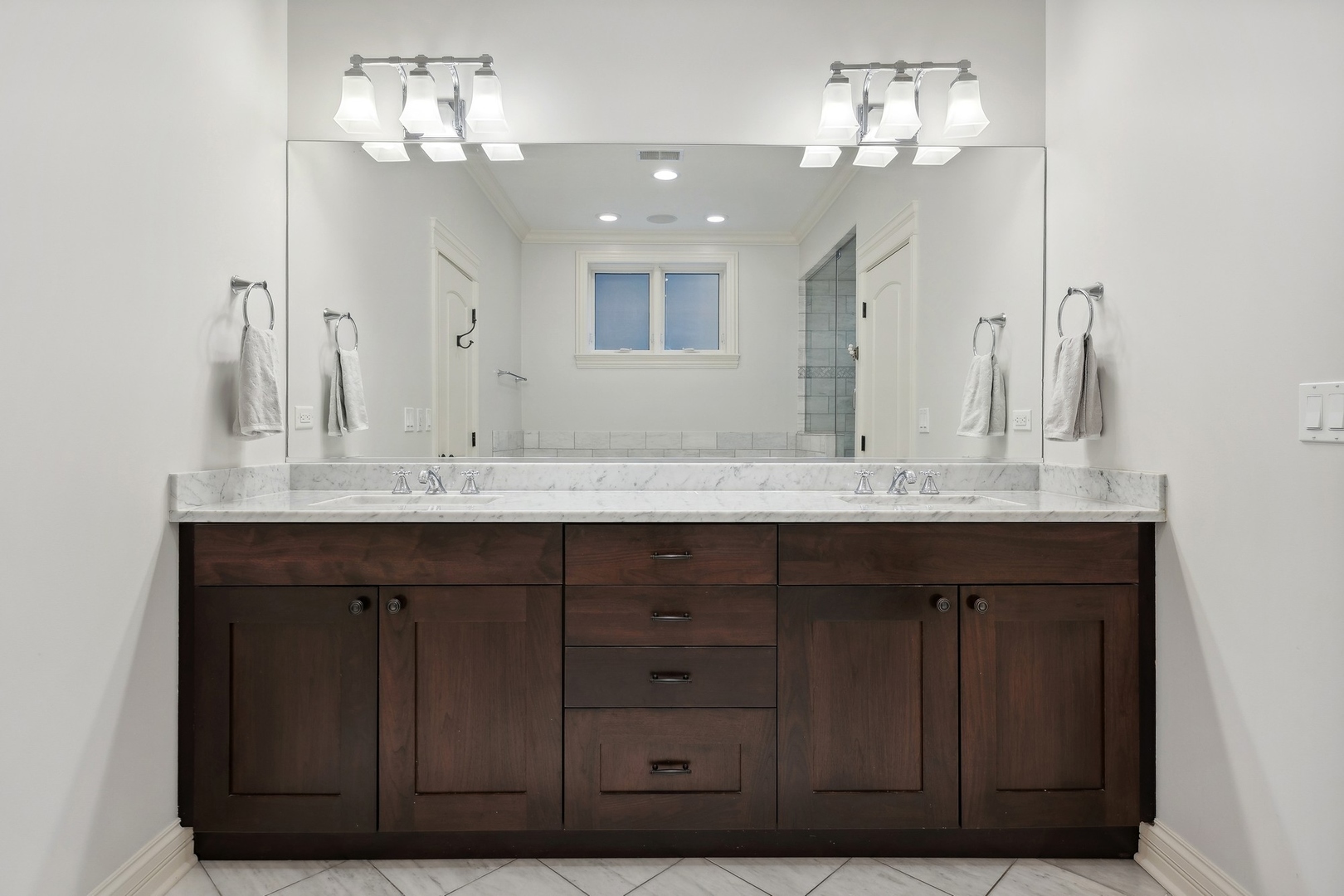 1520 West Diversey Parkway, Unit 1 Chicago, IL 60614 - Photo 21 of 31 a bathroom with a double vanity sink and a mirror