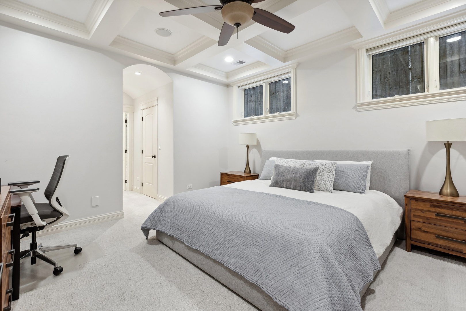 1520 West Diversey Parkway, Unit 1 Chicago, IL 60614 - Photo 23 of 31 a bedroom with a bed a desk and chair with wooden floor