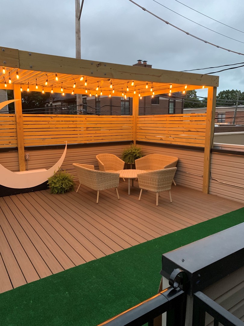 1520 West Diversey Parkway, Unit 1 Chicago, IL 60614 - Photo 27 of 31 a view of a chairs and table on the wooden deck