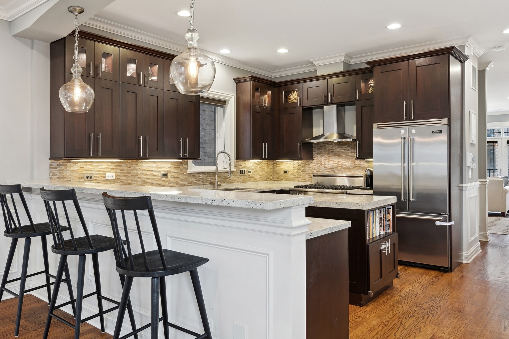 1520 West Diversey Parkway, Unit 1 Chicago, IL 60614 - Photo 10 of 31 a kitchen with kitchen island granite countertop a sink cabinets and stainless steel appliances