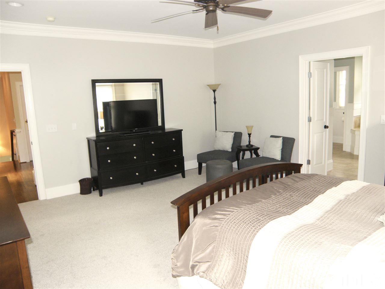 2702 Bedford Avenue Raleigh, NC 27607 - Photo 17 of 25 a bedroom with a bed and a dresser