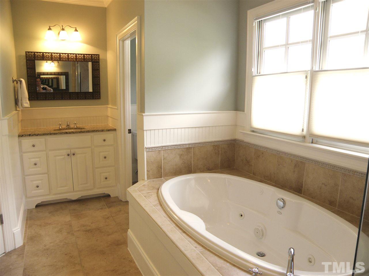 2702 Bedford Avenue Raleigh, NC 27607 - Photo 19 of 25 a bathroom with a bathtub and a sink