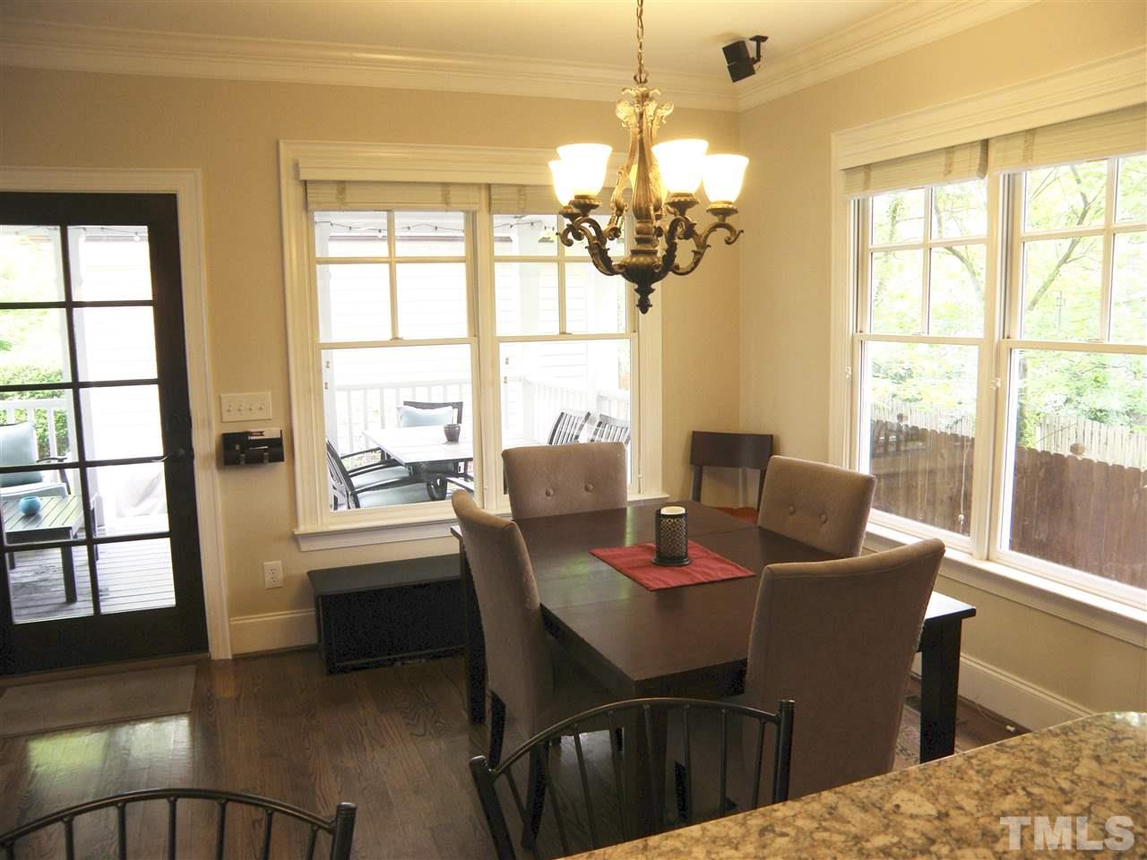 2702 Bedford Avenue Raleigh, NC 27607 - Photo 10 of 25 a dining room with furniture a chandelier and wooden floor