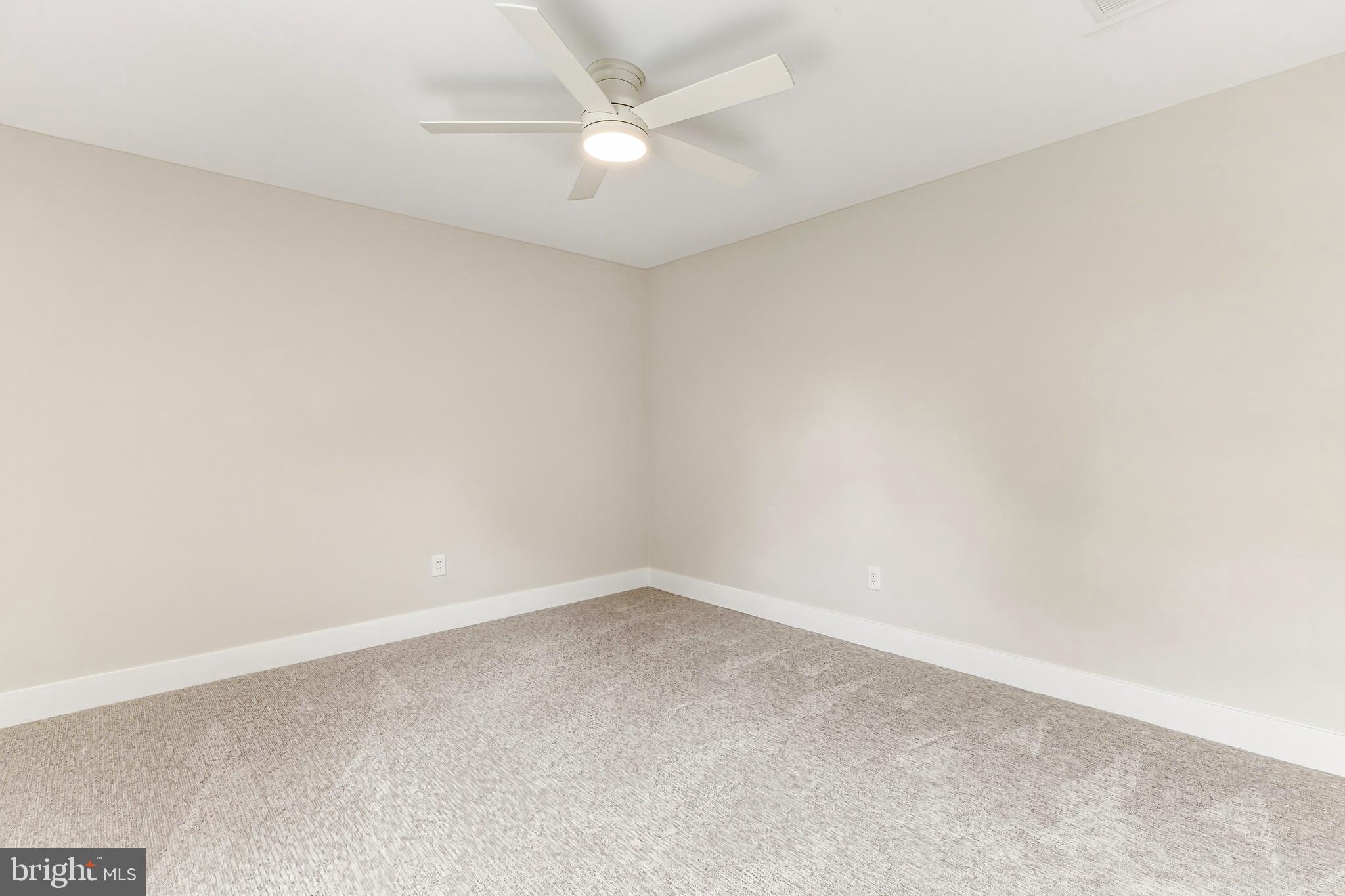 88 Freedom Road Sewell, NJ 08080 - Photo 27 of 30 an empty room with a ceiling fan and wooden floor